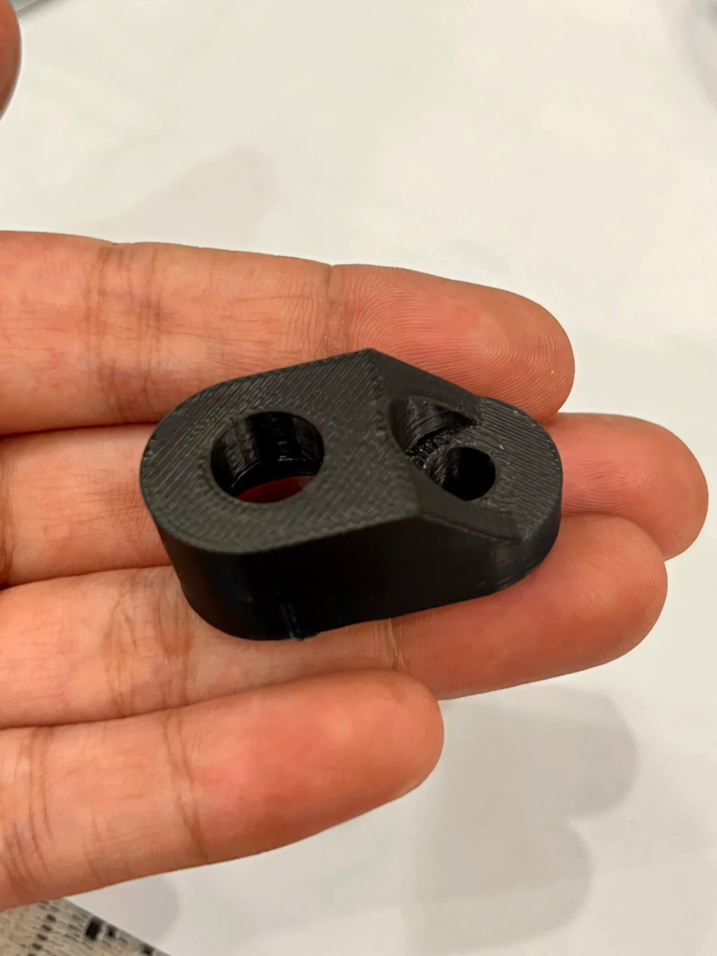 MotoNyx indicator adapter held in hand for scale