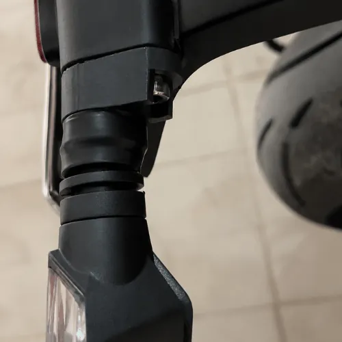 Indicator adapter bolted onto Triumph 400 rear bracket, close-up